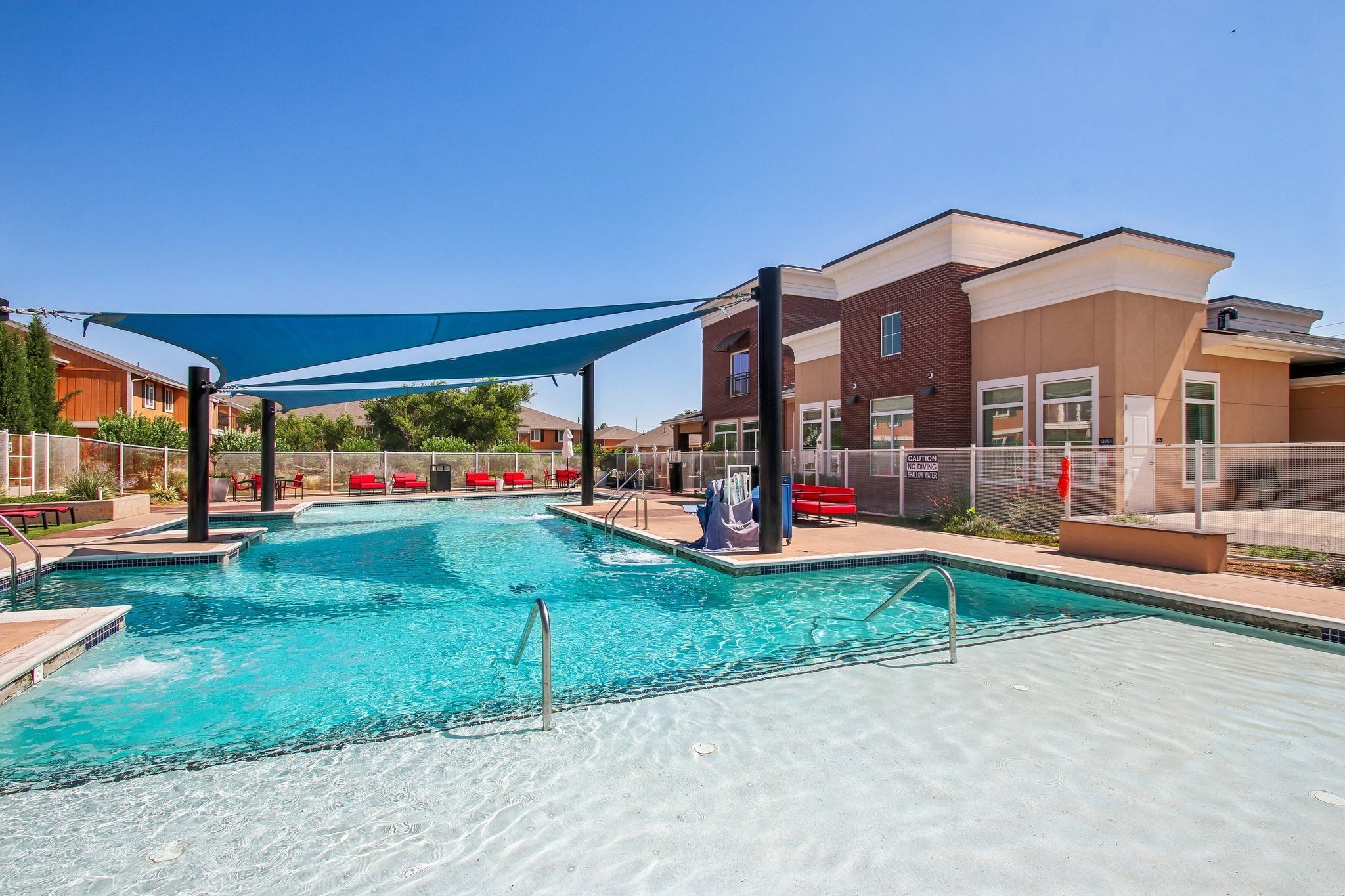 A large swimming pool with a blue tarp over it.